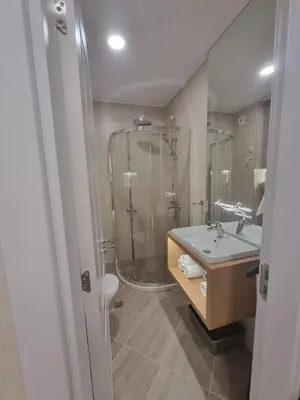 a bathroom with a shower and a sink and a toilet at Harmony Suites 16 in Sunny Beach