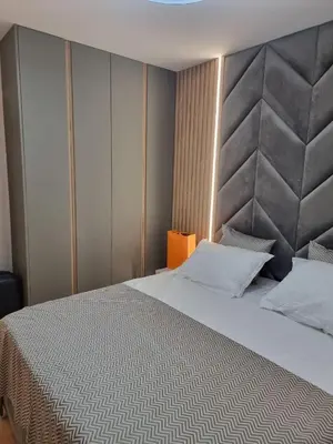 a bedroom with a large bed with a large headboard at Harmony Suites 16 in Sunny Beach