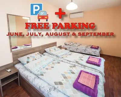 a bedroom with two beds and a sign that reads free parking at LAZUR - Nice Sunny Flat in Burgas City