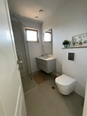 a bathroom with a toilet and a sink and a shower at Dimargo in Lozenets