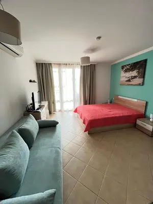 a living room with a bed and a couch at Aquamarine Studio in Santa Marina in Sozopol