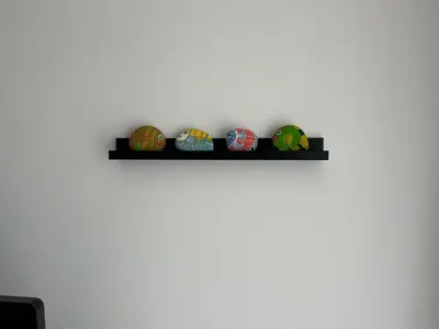 a shelf with four easter eggs on a wall at Aquamarine Studio in Santa Marina in Sozopol