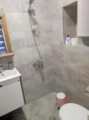 a bathroom with a shower with a toilet and a sink at Студио в центъра на стария Несебър in Nesebar