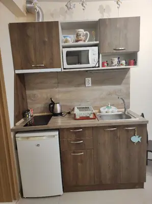 a small kitchen with a sink and a microwave at Студио в центъра на стария Несебър in Nesebar
