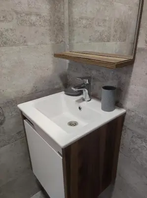 a bathroom with a white sink and a mirror at Студио в центъра на стария Несебър in Nesebar