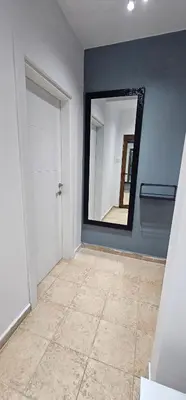 a room with a mirror and a tile floor at Studio Nikol in Burgas City