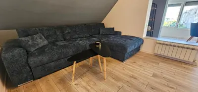 a living room with a couch and a table at Studio Nikol in Burgas City