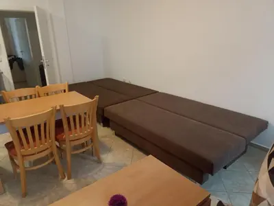 a couch in a living room with a table and chairs at SilverSprings Lucie in Sunny Beach