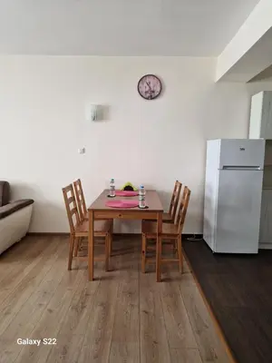 a kitchen with a table and chairs and a refrigerator at De Ja Vu- Zdravez in Burgas City
