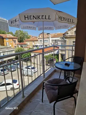 a balcony with a table and chairs and a view of a city at De Ja Vu- Zdravez in Burgas City