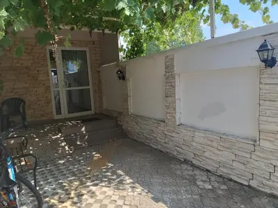a white garage door on a brick building at Sunny Beach Apartment, Kokiche Hotel - white building Liliya in Sunny Beach