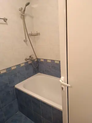 a bath tub in a bathroom with a shower at Sunny Beach Apartment, Kokiche Hotel - white building Liliya in Sunny Beach