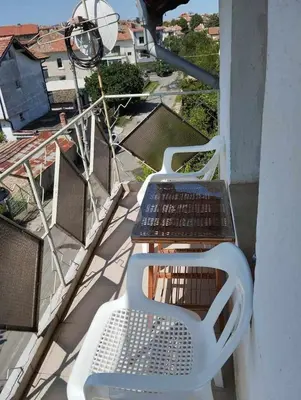 two chairs and a table on a balcony at Къща за гости дом Попови Черноморец in Chernomorets