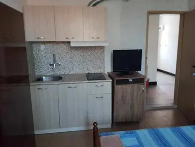 a kitchen with a sink and a tv on a counter at Къща за гости дом Попови Черноморец in Chernomorets