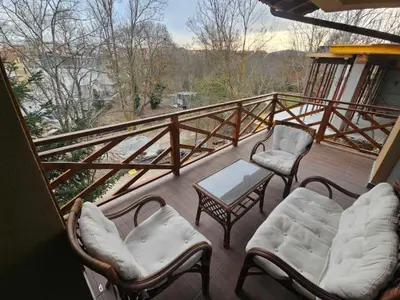 a balcony with two chairs and a table and two chairs at Denevi' seaside apartment - 2 bedrooms in Lozenets