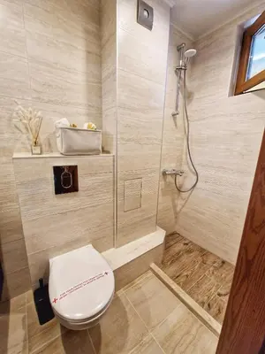 a bathroom with a toilet and a shower at Delux Apart Vulchevi with Parking in Burgas City