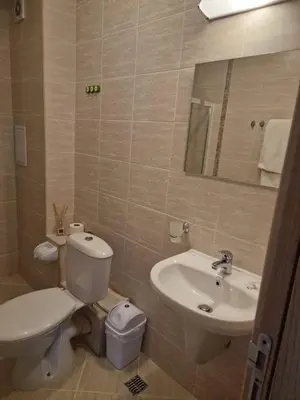 a bathroom with a toilet and a sink at Messembria Resort in Nesebar