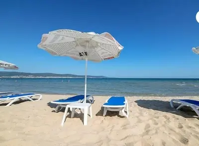 a group of chairs and an umbrella on the beach at Messembria Resort in Nesebar