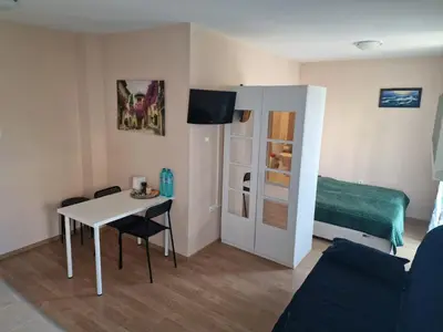 a small room with a table and a bed at Messembria Resort in Nesebar