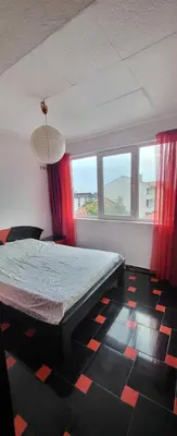 a bedroom with a bed in a room with windows at Unique Apartment with Balcony in Pomorie Old Town by Flat Mаnаger in Pomorie