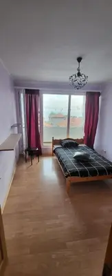 a bedroom with a bed and a large window at Unique Apartment with Balcony in Pomorie Old Town by Flat Mаnаger in Pomorie