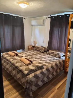 a bedroom with a bed with two pillows on it at Вила 50 in Atiya