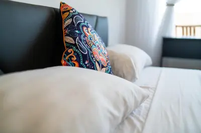 a pillow sitting on top of a bed at Lazur Sea View in Burgas City