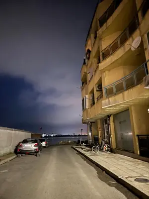 a car parked in a parking lot next to a building at Studiosaltsea in Pomorie