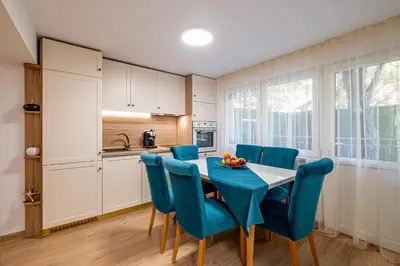 a kitchen and dining room with a table and chairs at Angel Home 2bdrm Modern Apartment in Varna City