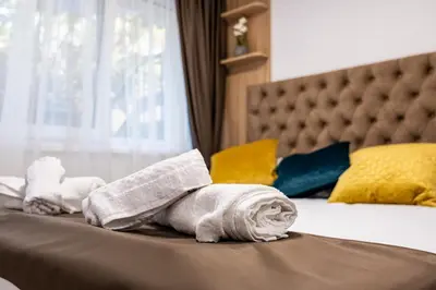 a pile of towels sitting on top of a bed at Angel Home 2bdrm Modern Apartment in Varna City