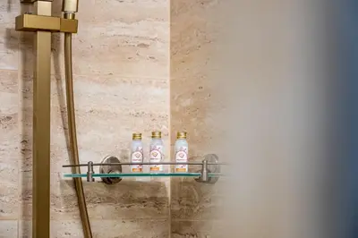 a shelf with four bottles of alcohol on a wall at Angel Home 2bdrm Modern Apartment in Varna City