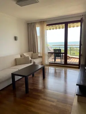 a living room with a couch and a coffee table at Private apartments Ravda-Emerald in Ravda