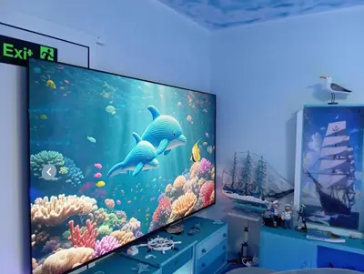 a flat screen tv in a room with an aquarium at Apartament ALBATROS in Burgas City