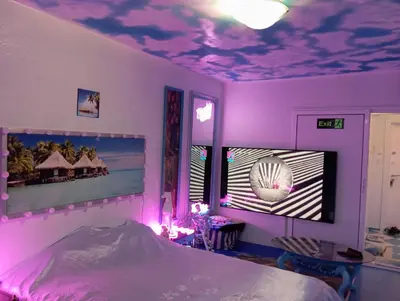 a bedroom with a purple ceiling and a bed at Apartament ALBATROS in Burgas City