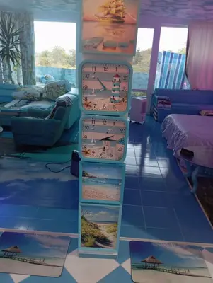 a room with three shelves with a clock on the wall at Apartament ALBATROS in Burgas City