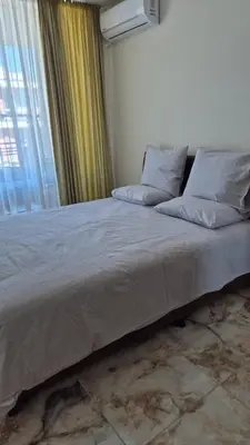 a large bed in a room with a window at Karolina complex appartment in Sunny Beach