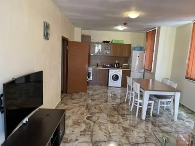 a kitchen and dining room with a table and chairs at Karolina complex appartment in Sunny Beach