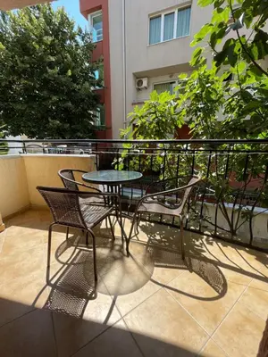 a patio with a table and chairs on a balcony at Alatoni Beach Hotel in Sozopol