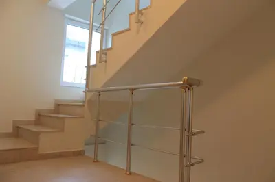 a staircase in a home with a glass railing at Stela Guest House in Tsarevo