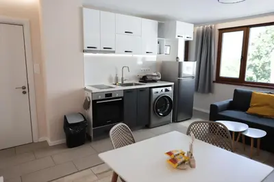 a kitchen and living room with a sink and a dishwasher at Azur Holiday Burgas - self check-in in Burgas City