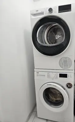 two washing machines stacked on top of each other at Ann's apartment in Varna City