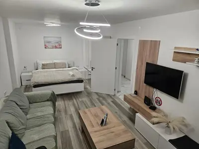 a living room with a couch and a flat screen tv at Ann's apartment in Varna City