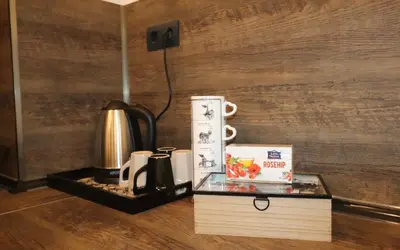 a glass table with a coffee maker and a coffee pot at Relax apartment with parking in Varna City