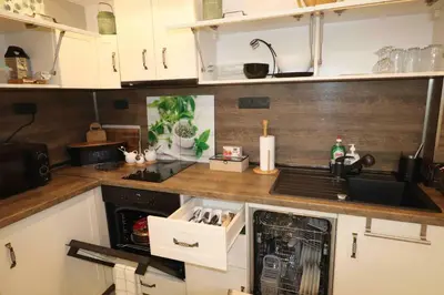a kitchen with white cabinets and a counter top at Relax apartment with parking in Varna City