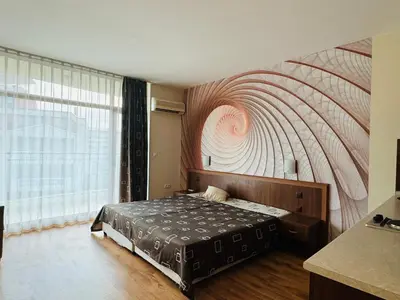 a bedroom with a bed with a painting on the wall at GRENADA 322C Studio Sunny Beach in Sunny Beach