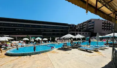 a large swimming pool with people sitting around it at GRENADA 322C Studio Sunny Beach in Sunny Beach