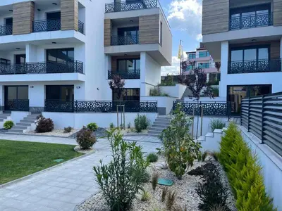an apartment building with a courtyard with plants at Студио Морски дни-топ локация в Созопол in Sozopol