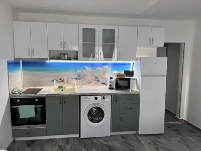 a kitchen with a sink and a washing machine at Студио Морски дни-топ локация в Созопол in Sozopol