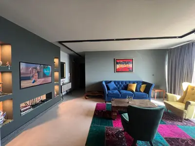 a living room with a blue couch and a table at Apartament Panorama in Pomorie