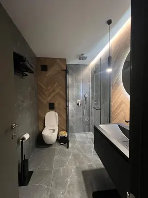 a bathroom with a toilet and a shower and a sink at Apartament Panorama in Pomorie